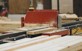 A photo of lumber cuts being made with specialized machinery.