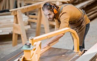 A photo of a man wearing ear protection while providing professional resawing services.