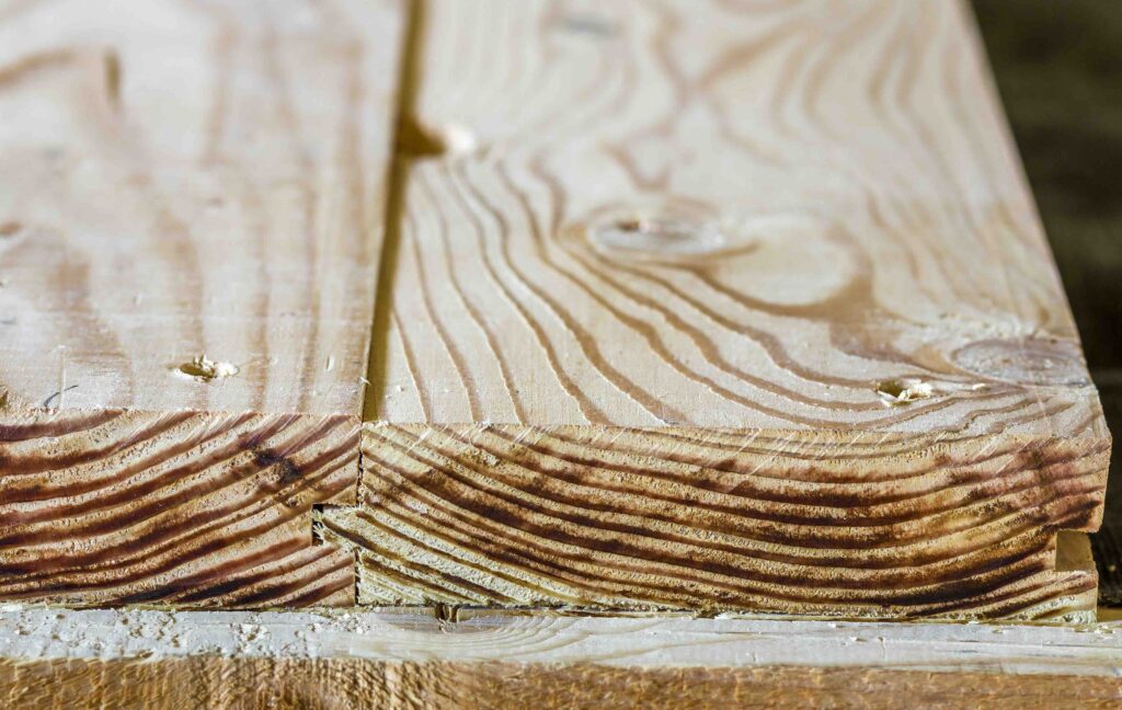A closeup photo of lumber and demonstrating the importance of resawing services.
