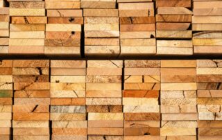 A photo of stacked lumber following commercial pack cutting services.