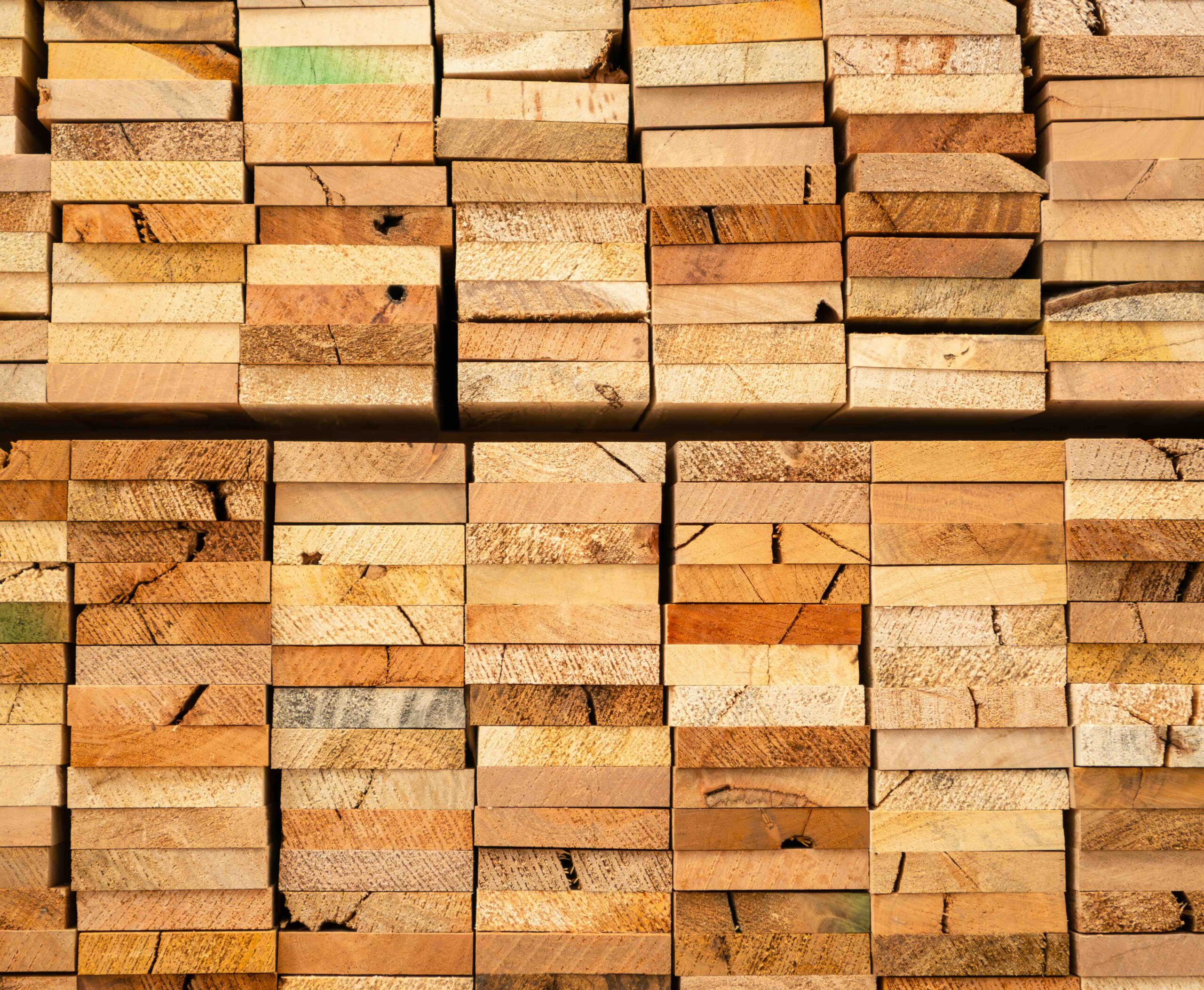 A photo of stacked lumber following commercial pack cutting services.